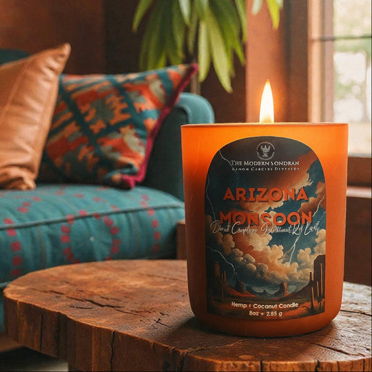 Best-selling Arizona Monsoon Candle set in a southwestern decorated living room in terracotta earthtones. The arizona monsoon candle is lit, filling the room with the scent of desert creosote and rain drenched sonoran desert earth.
