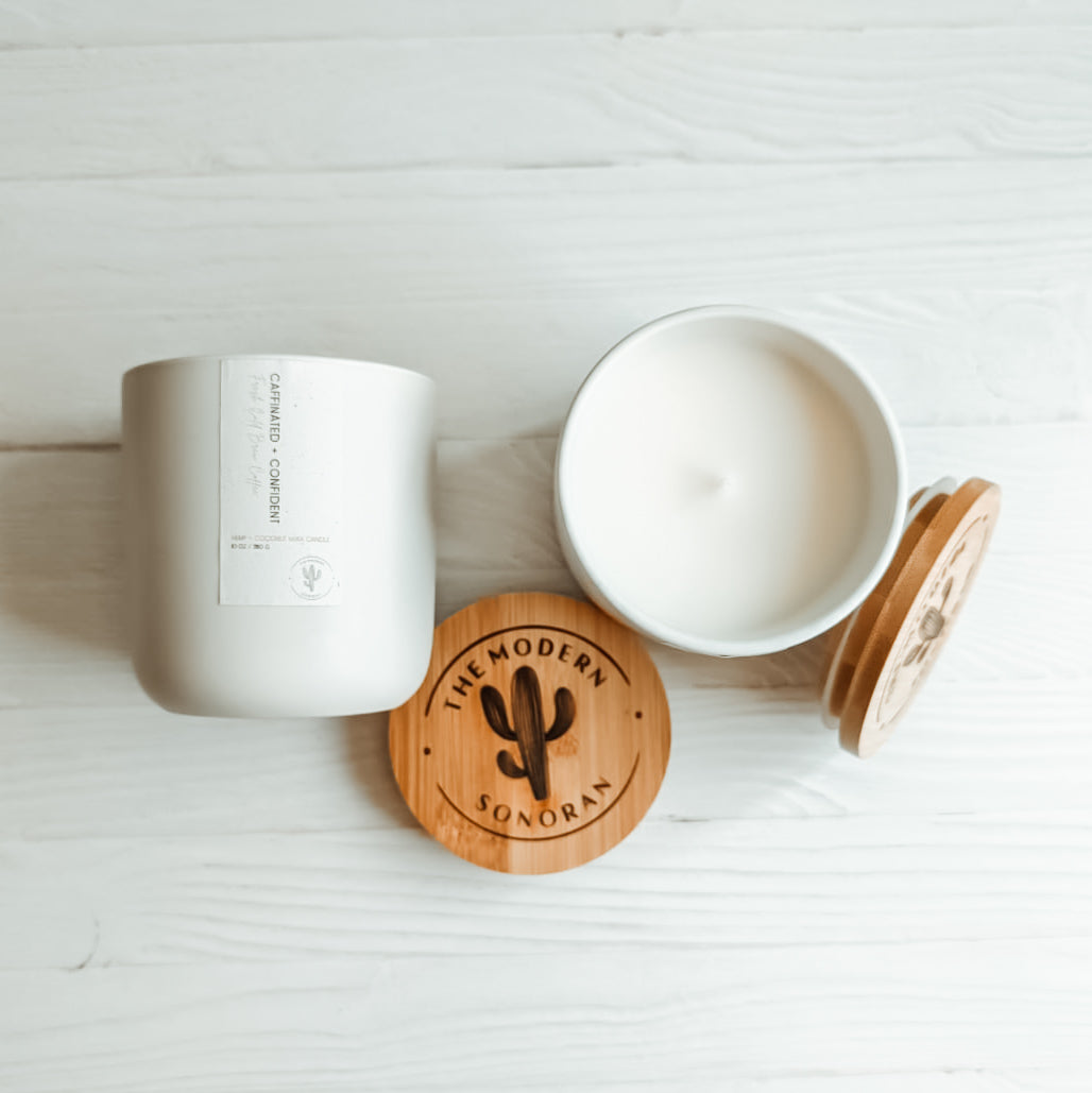 Caffeinated & Confident Coffee Hemp and Coconut wax candle. One of the candles from our modern farmhouse collection, this Cold Brew Coffee scented clean ingredient, non-toxic candle is soy free, paraffin free, carcinogen free, mutagen free, and contain no hormone disruptors. Sustainably sourced ingredients. In a 10 oz. soft white Ceramic jar with bamboo lids. Side and top view shown.