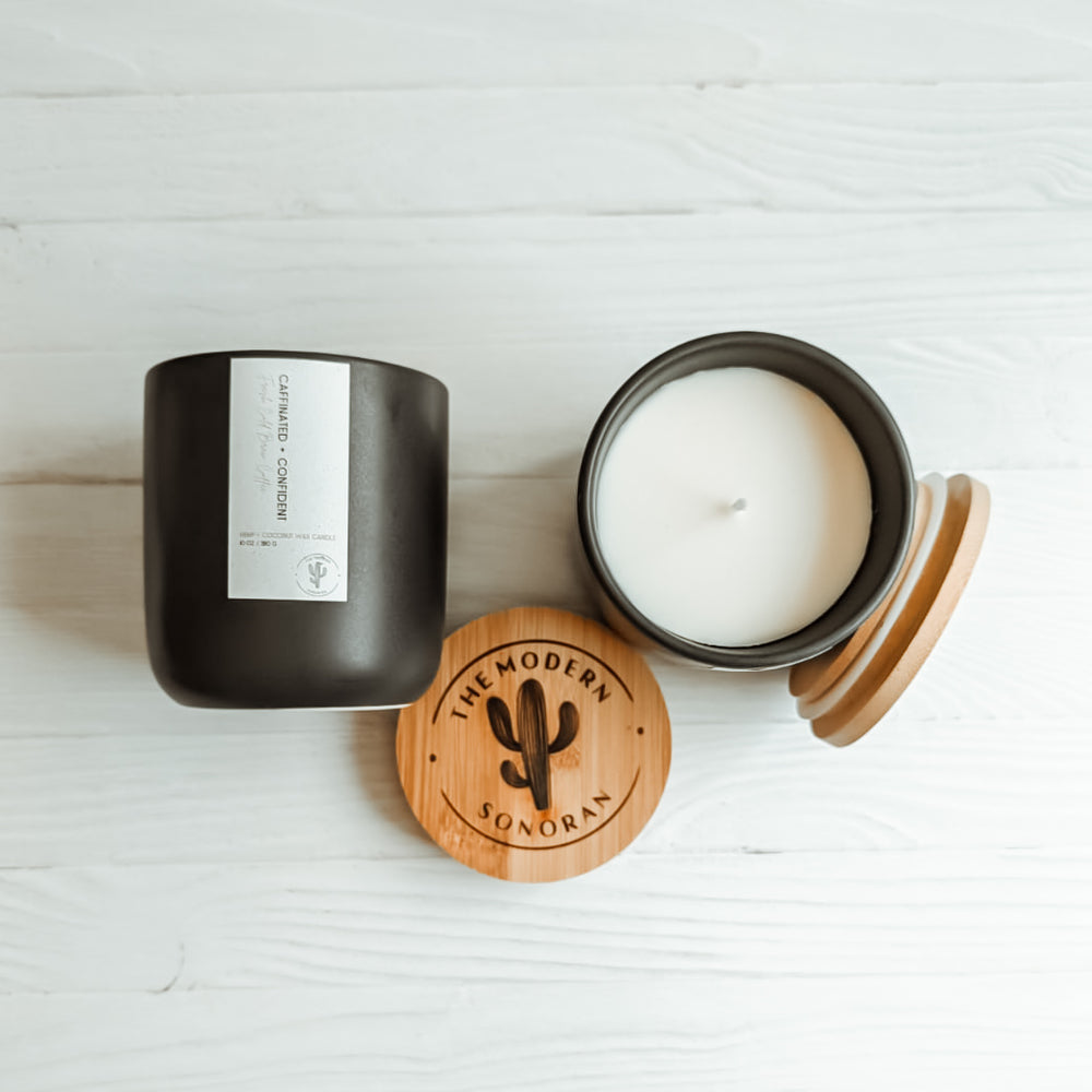 Caffeinated & Confident Coffee Hemp and Coconut wax candle. One of the candles from our modern farmhouse collection, this Cold Brew Coffee scented clean ingredient, non-toxic candle is soy free, paraffin free, carcinogen free, mutagen free, and contain no hormone disruptors. Sustainably sourced ingredients. In a 10 oz. charcoal Ceramic jar with bamboo lids. Side and top view shown.