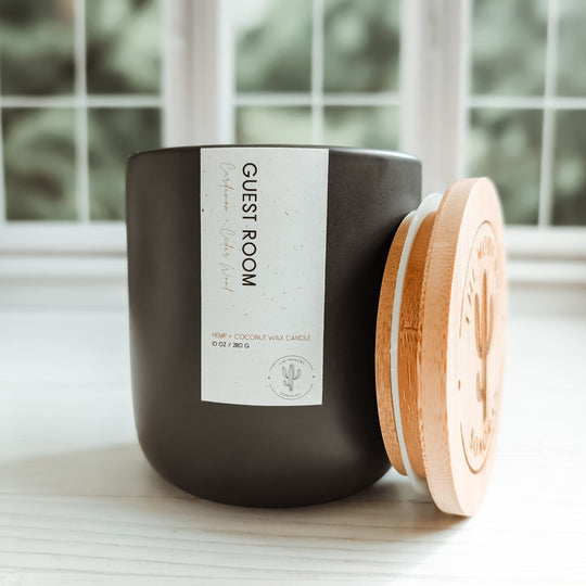 Pictured is the Guest Room, cedarwood and cardamom scented in a Charcoal colored ceramic jar. It is part of the Modern Farmhouse Collection, a collection of candles designed for the farmhouse decor aesthetic. It is made from our own, unique Hemp & Coconut Wax. It is both soy free and paraffin free - non-toxic, sustainable, & clean ingredient. No Carcinogens, no mutagens, no hormone disruptors, organ toxins, ect. Literally the best candle ever!