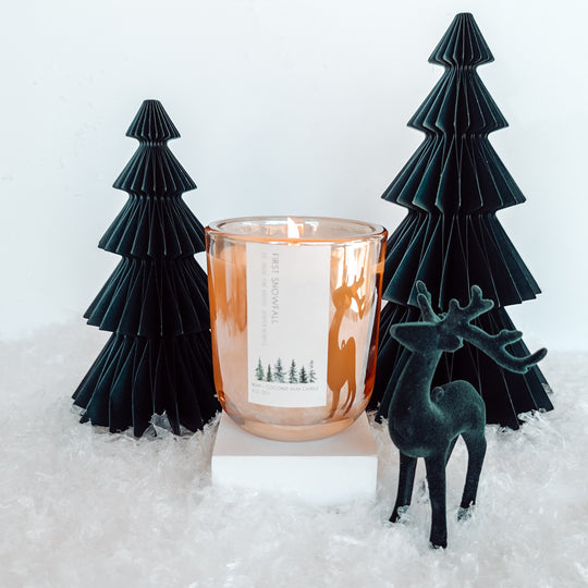 he refreshing scent of mint and eucalyptus, mingled with pine and juniper berries from the evergreen tree woods that borders your home. A hint of vanilla mixed with Christmas spice lingers, as cozy and comforting as a warm, snuggly throw in front of the fireplace. First Snowfall brings the magic of snow-dusted Christmas mornings to life, wrapping your home in the serene beauty of the season. Made with hemp wax. no seed oils such as soy. Paraffin free. holiday decor. Best-selling holiday candle. winter.