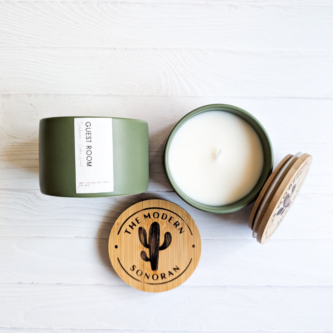 Pictured is the Guest Room scented Candle in Sage green. It smells like Cardamom and Cedarwood. It is part of the Modern Farmhouse Collection, a collection of candles designed for the farmhouse decor aesthetic. It is made from our own, unique Hemp & Coconut Wax. It is both soy free and paraffin free - non-toxic, sustainable, & clean ingredient. No Carcinogens, no mutagens, no hormone disruptors, organ toxins, ect. Literally the best candle ever!