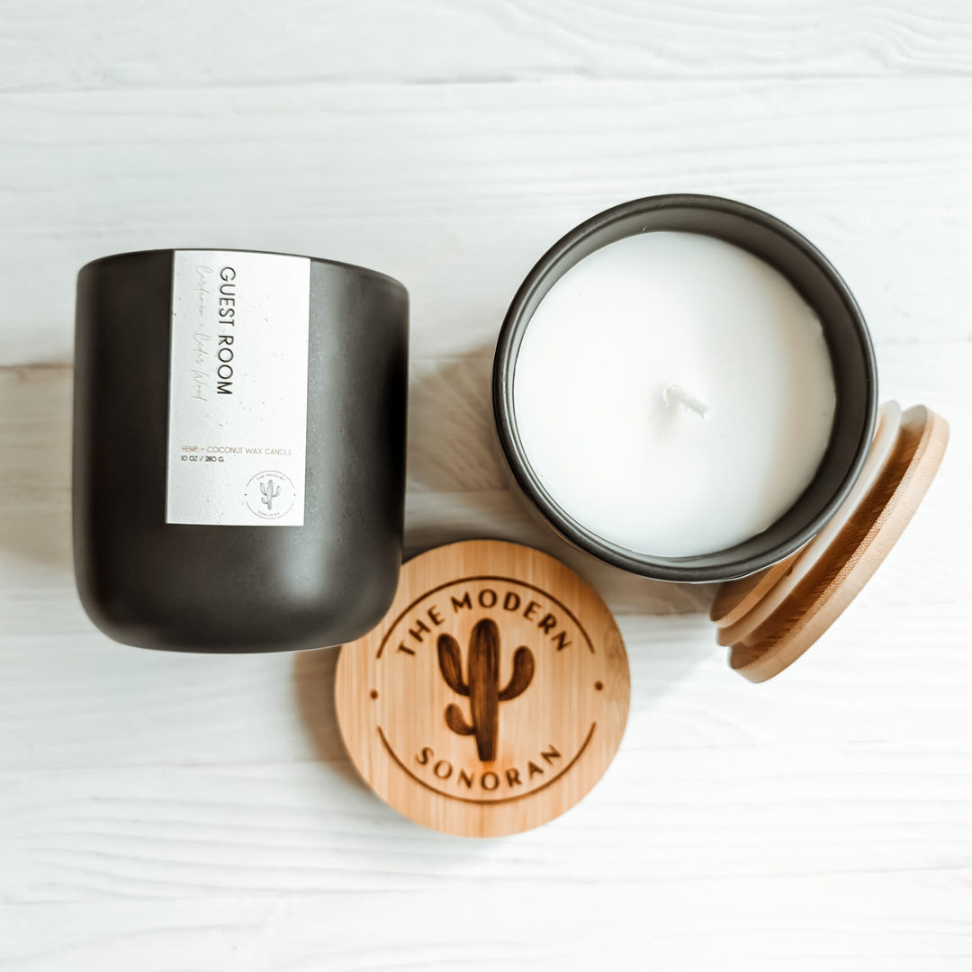 Pictured is the guest room scented candle that smells of cardamom and cedarwood. Charcoal colored ceramic jar. It is part of the Modern Farmhouse Collection, a collection of candles designed for the farmhouse decor aesthetic. It is made from our own, unique Hemp & Coconut Wax. It is both soy free and paraffin free - non-toxic, sustainable, & clean ingredient. No Carcinogens, no mutagens, no hormone disruptors, organ toxins, ect. Literally the best candle ever!