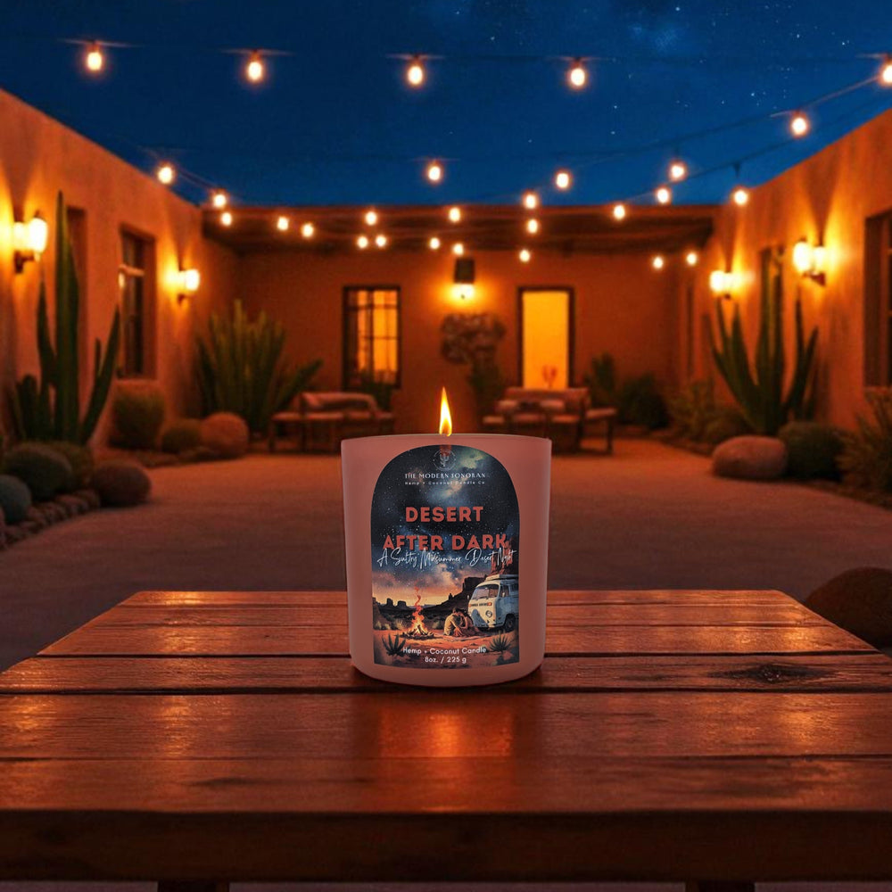 Arizona candle labeled 'Desert After Dark' on a wooden table with a nighttime outdoor setting.