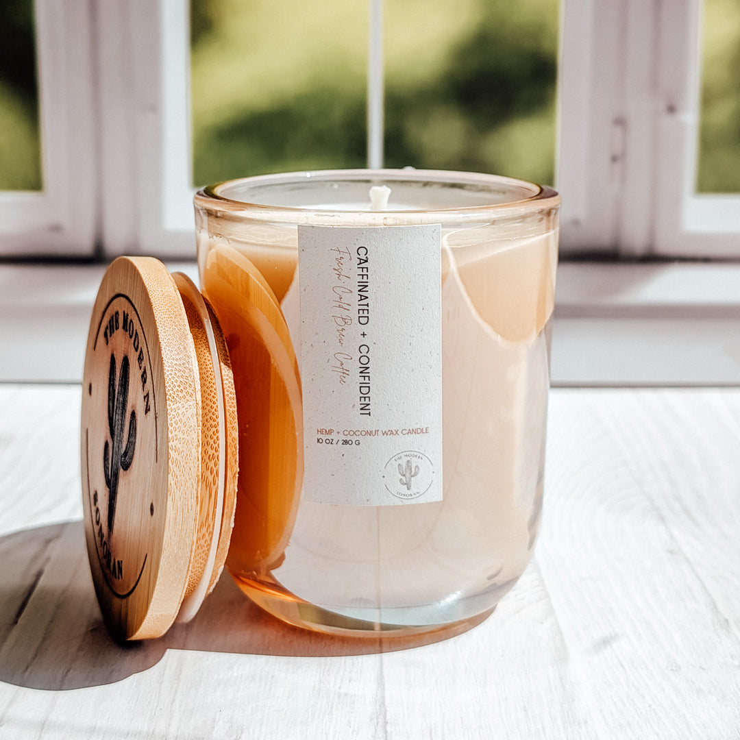 a SUPER EXTREME close up shot of a Caffinated and Confident candle in a glass jar on a windowsill