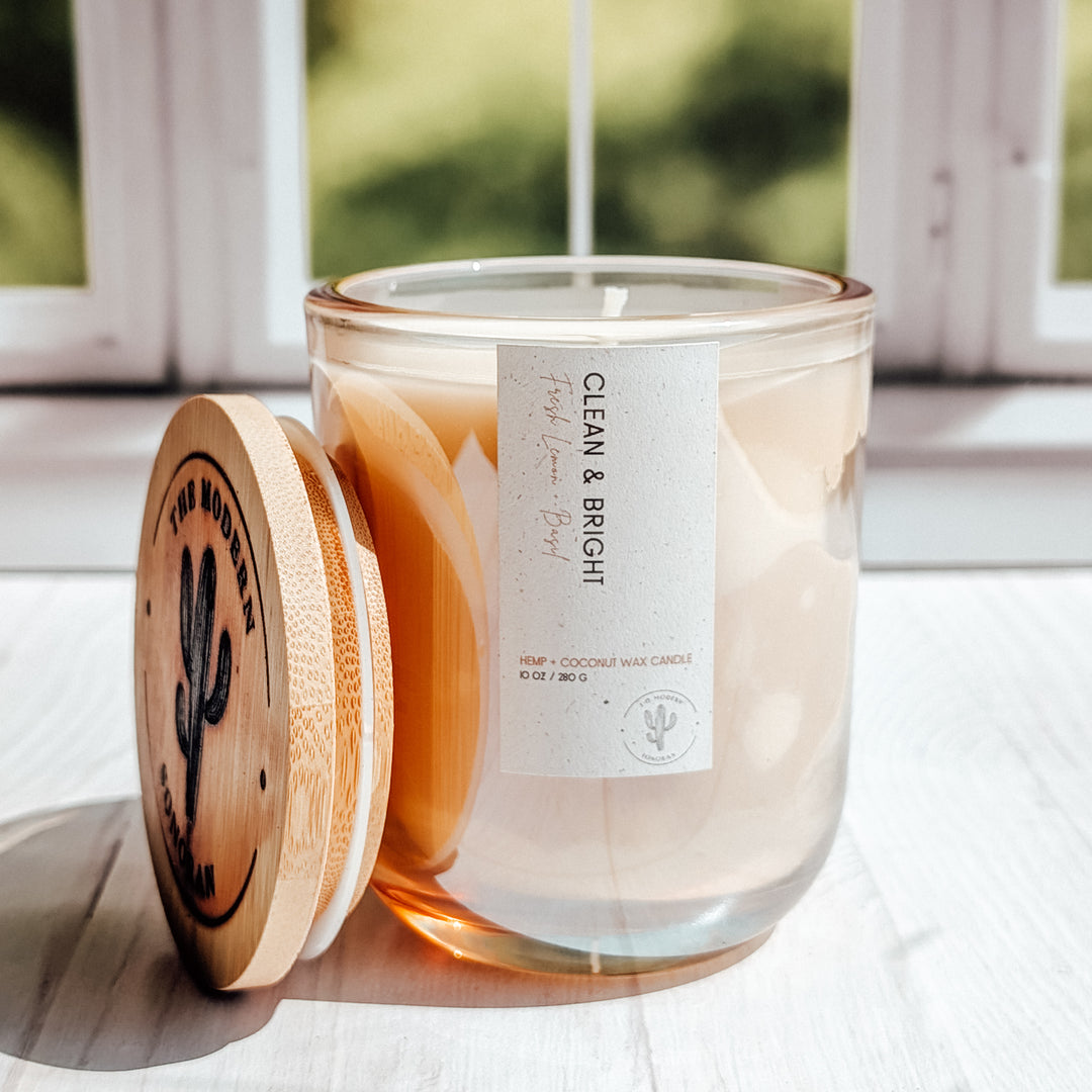yet another close up shot of a Clean and Bright candle in a glass jar on a windowsill.