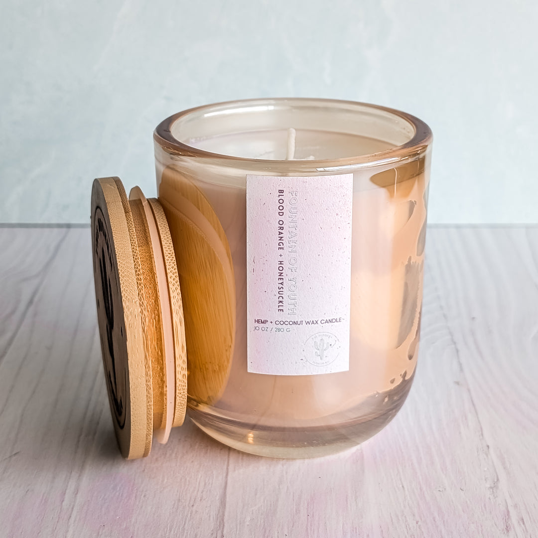 A Fountain of Youth candle in a Glass jar on a table